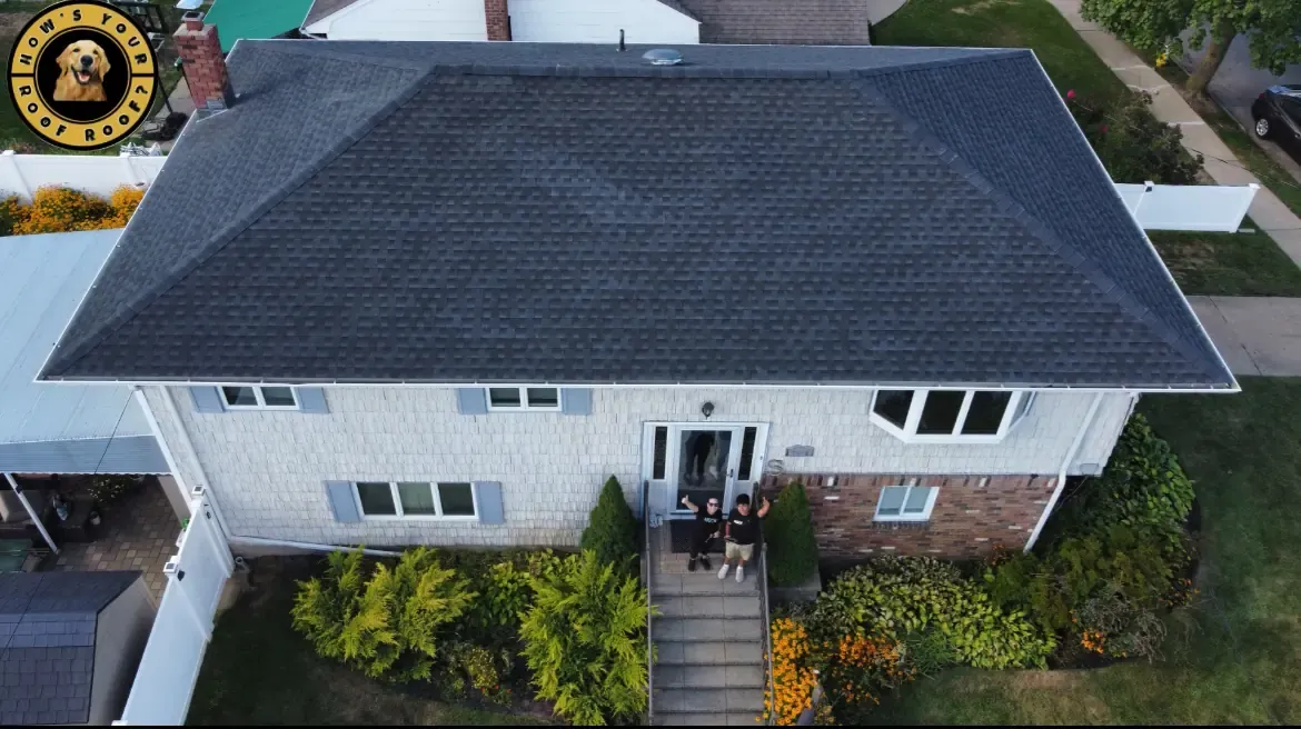 Aerial view of a completed dark shingle roof on a split-level home